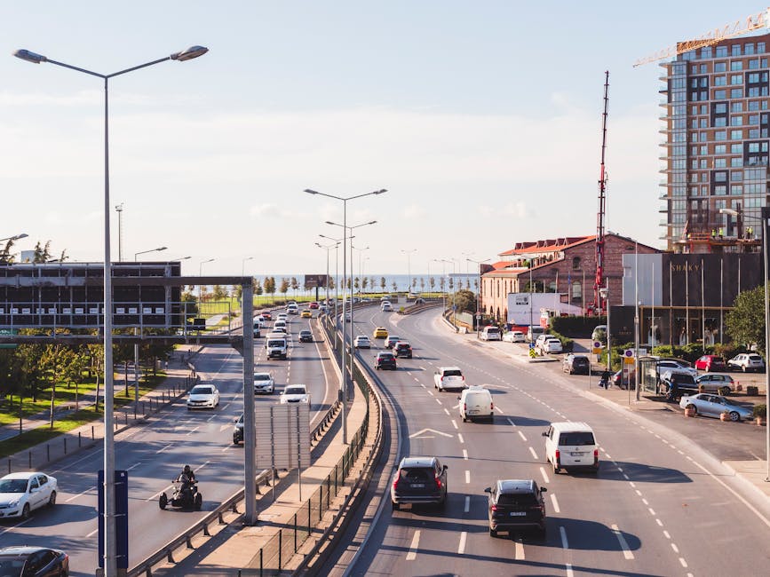 Busy highway with cars under a clear blue sky, showcasing urban life and infrastructure.